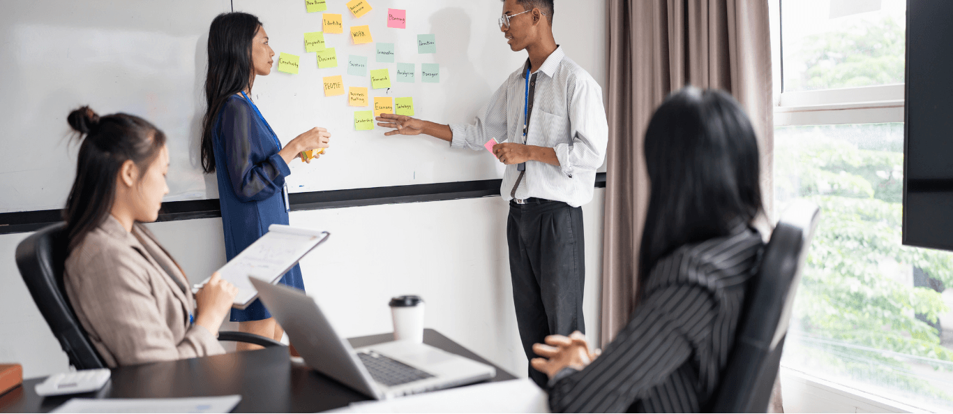 People Meeting in Front of White board